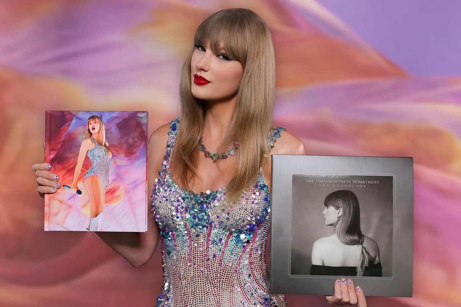 Taylor Swift posing with the Eras Tour book and 'The Tortured Poets Department: The Anthology' album.