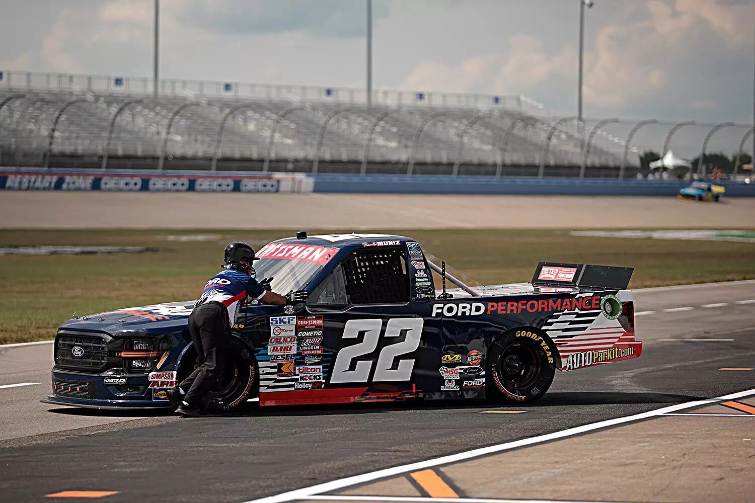 A crew member pushes the #22 Ford Performance Ford, driven by Frankie Muniz during practice for the NAStruck Craftsman Truck Series Rackley Roofing 200 at Nashville Superspeedway on June 28, 2024, in Lebanon, Tenn.