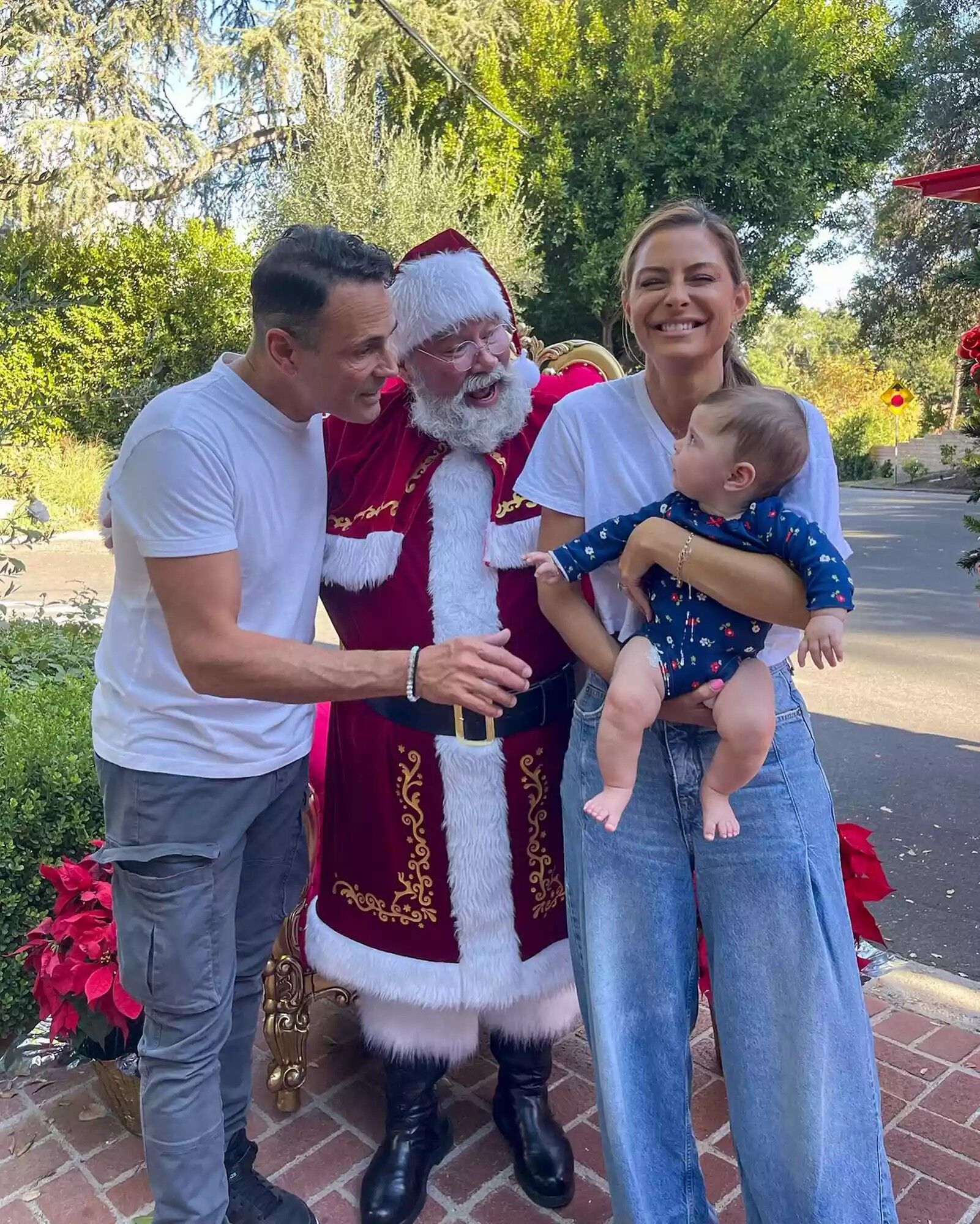 Maria Menounos, Keven Undergaro, and their daughter Athena pose with Santa.