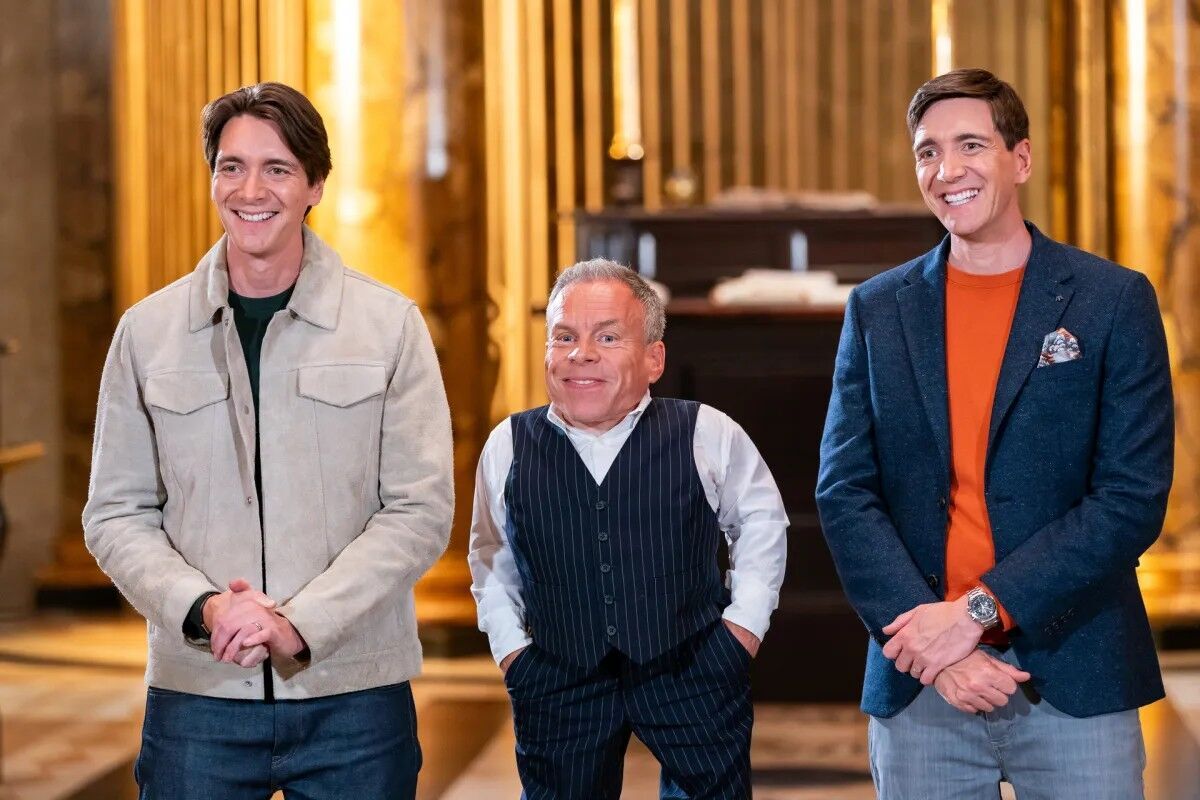 Hosts James Phelps and Oliver Phelps with guest judge Warwick Davis.