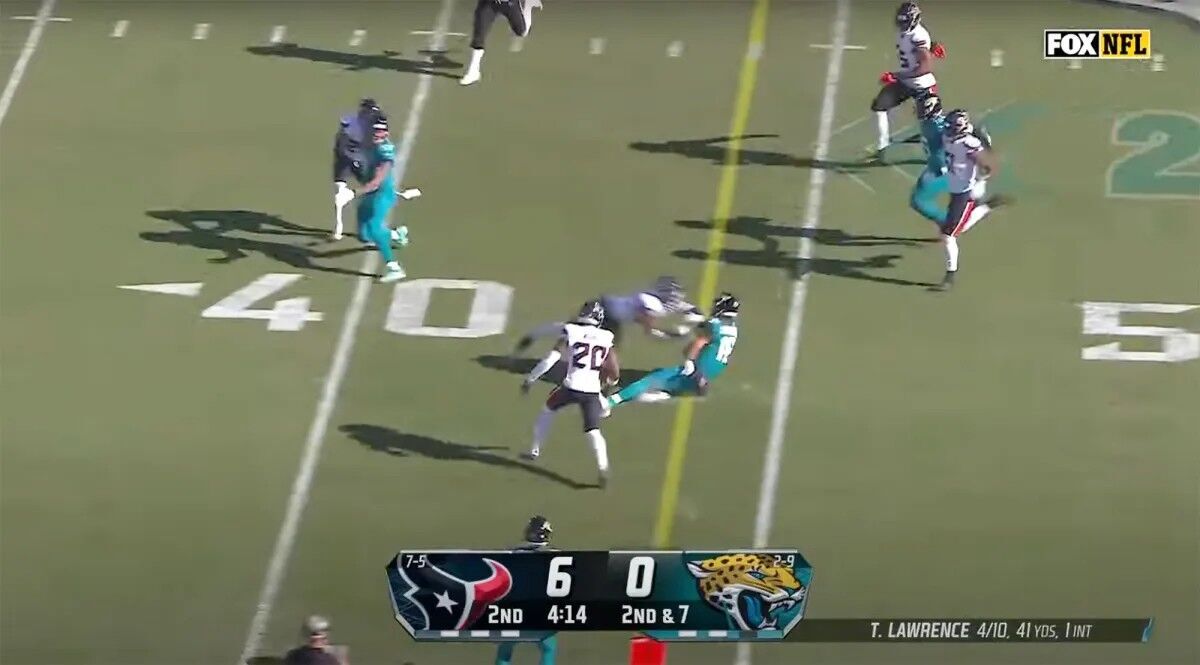 Azeez Al-Shaair of the Houston Texans hits Jaguars quarterback Trevor Lawrence.