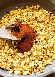 Adding spices to the corn