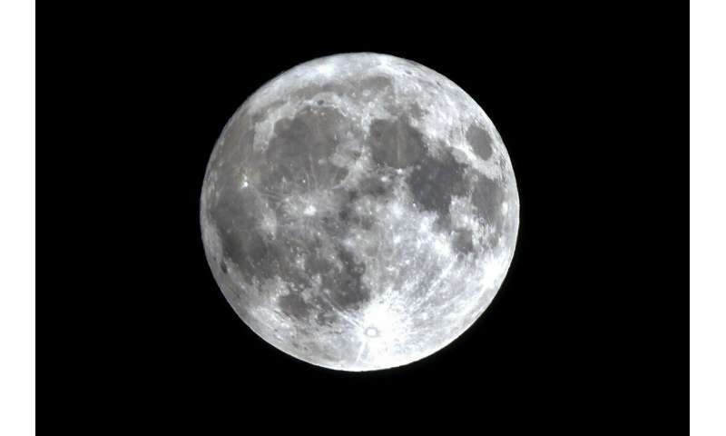 A nearly full supermoon rises in the sky after rain in Beijing, Monday, Aug. 19