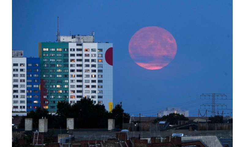 The supermoon rises from behind a resident building in Berlin, Monday 20