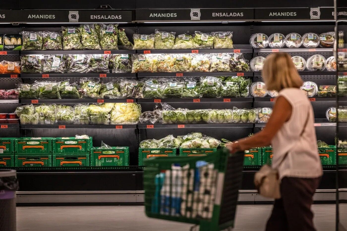 A customer in the fresh groceries section of a supermarket in Barcelona