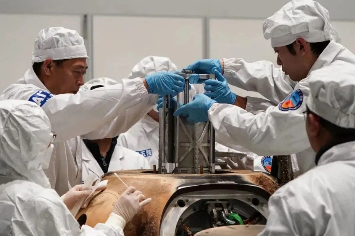 Technicians remove the sample canister from China's Chang'e 5 spacecraft, which returned moon dirt and rock to Earth in December 2020.