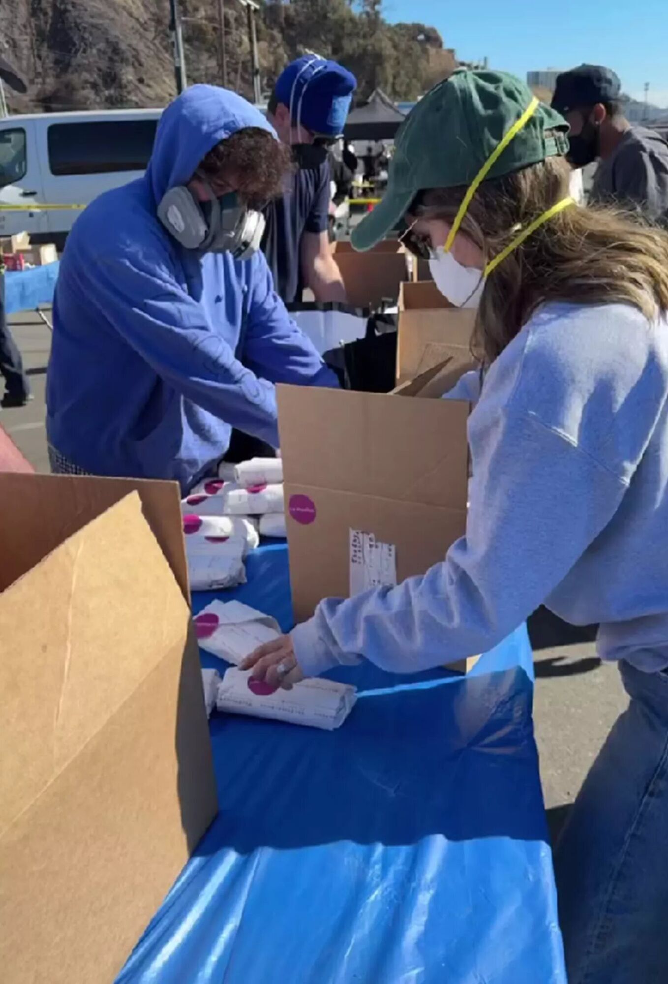 Benny Blanco and Selena Gomez handing out food