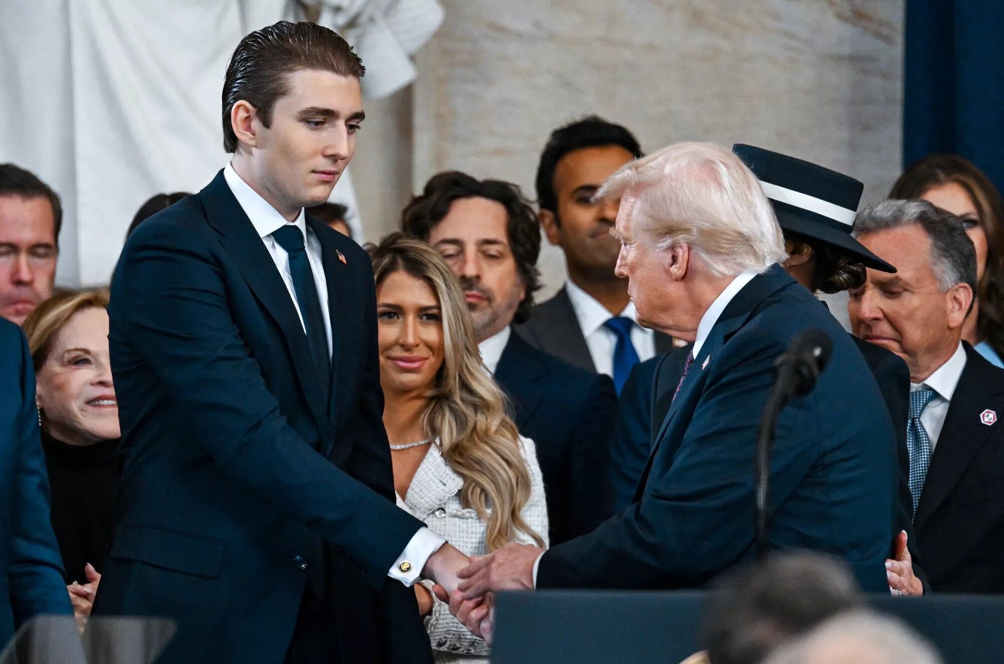 Barron Trump shakes his father's hand at the inauguration on Jan. 20, 2025.