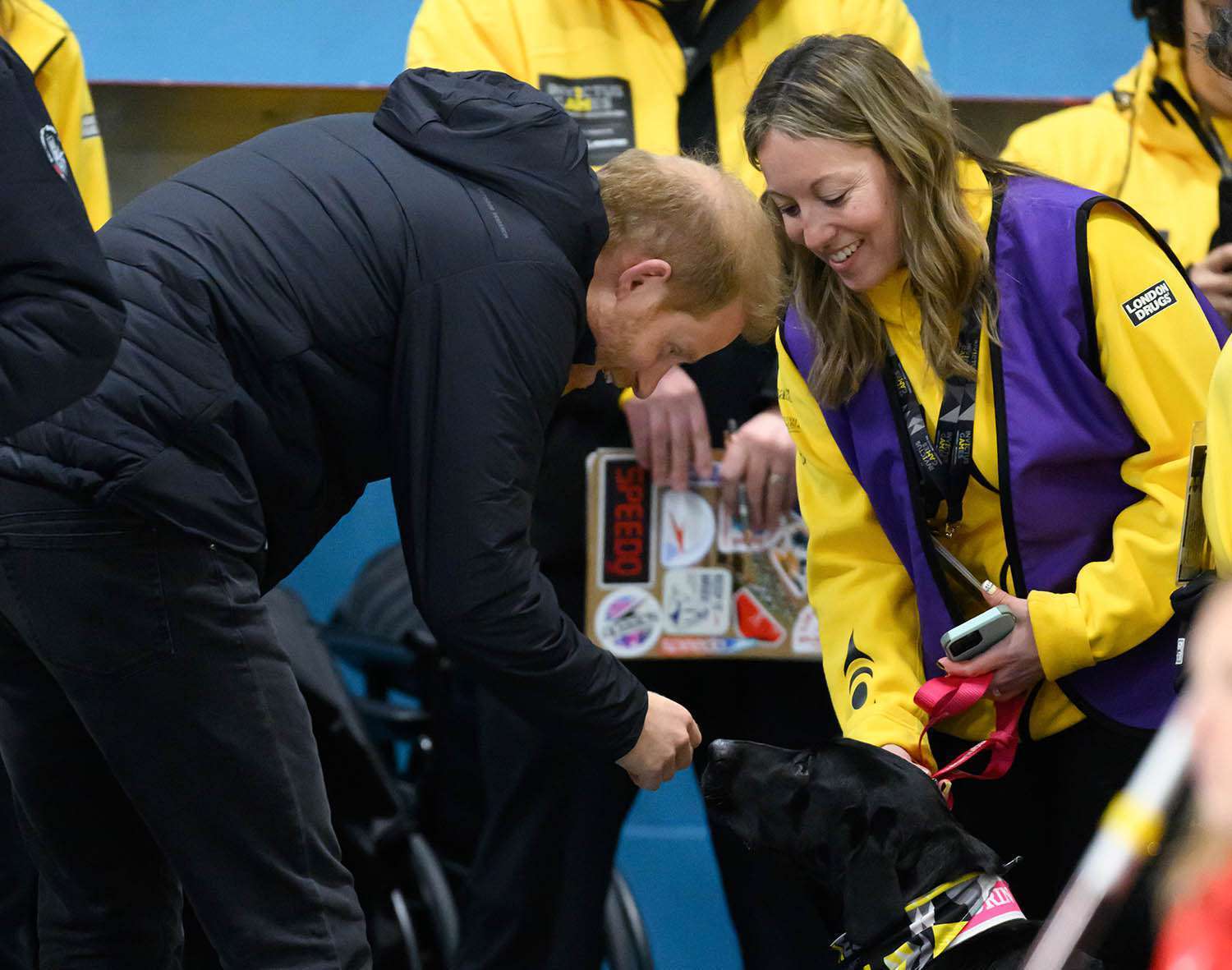 Prince Harry with Thorn the dog and Ali Harper at the Invictus Games in Canada on Feb. 9, 2025.