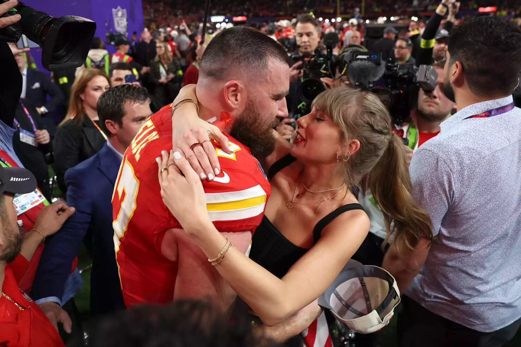 Travis Kelce and Taylor Swift celebrating on the field after the Chiefs beat the San Francisco 49ers in the 2024 Super Bowl.