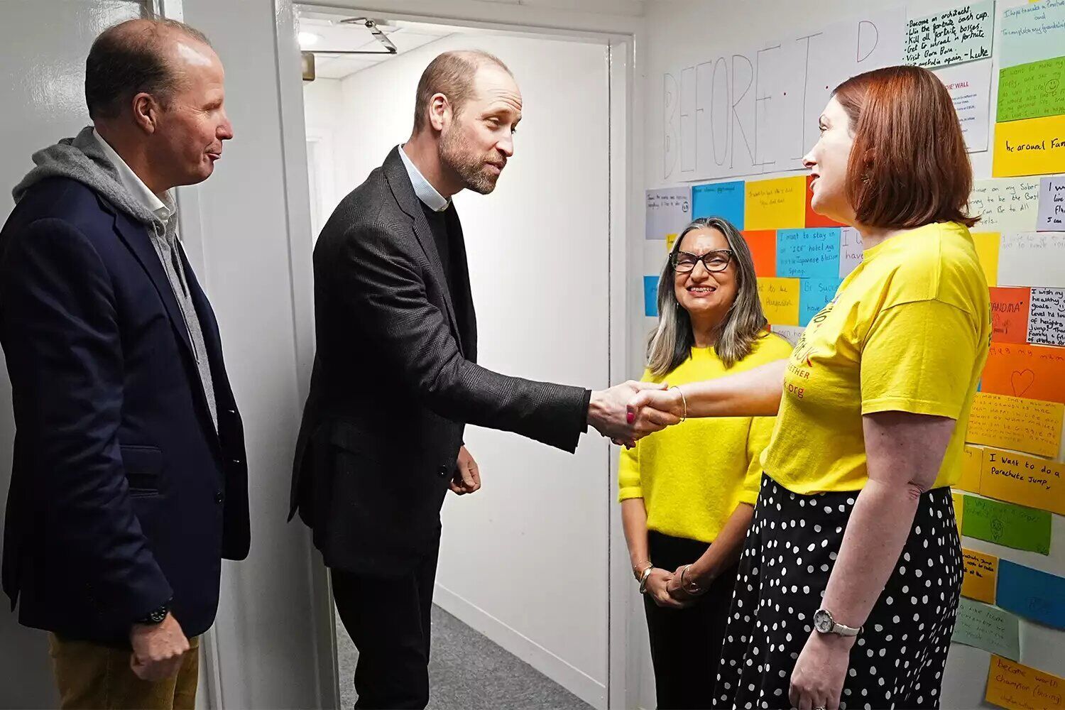 Prince William, Prince of Wales, is met by (left to right) Alex Fitzgibbons, Maninder Hayre and Sophie Cartwright