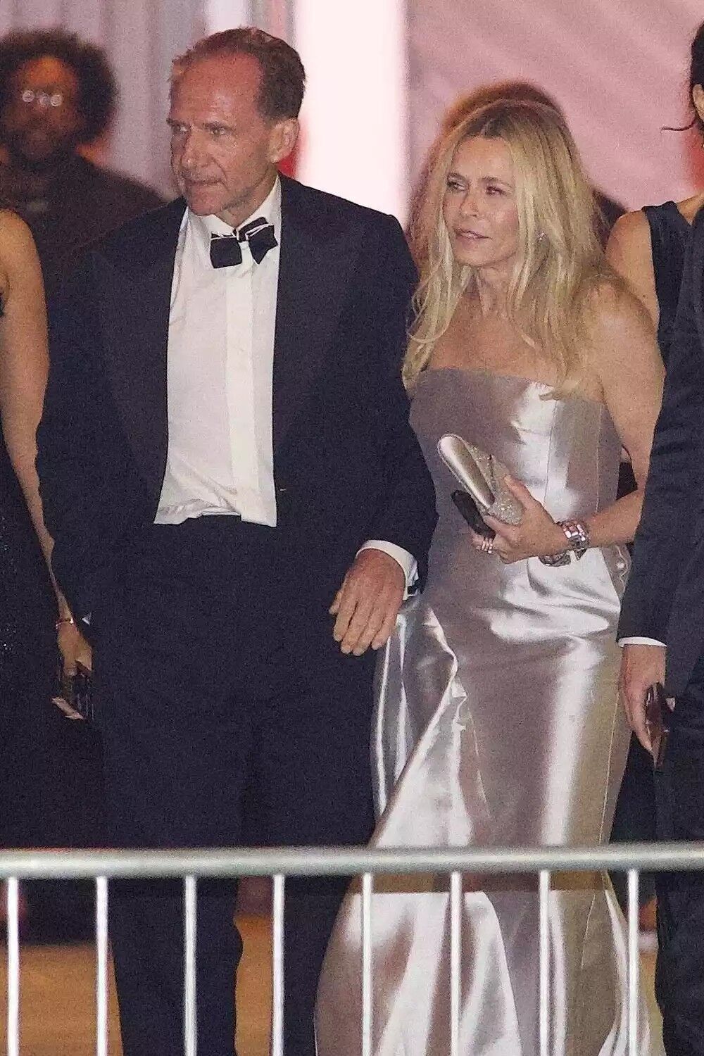 Chelsea Handler and Ralph Fiennes leaving the 2025 Vanity Fair Oscar Party.