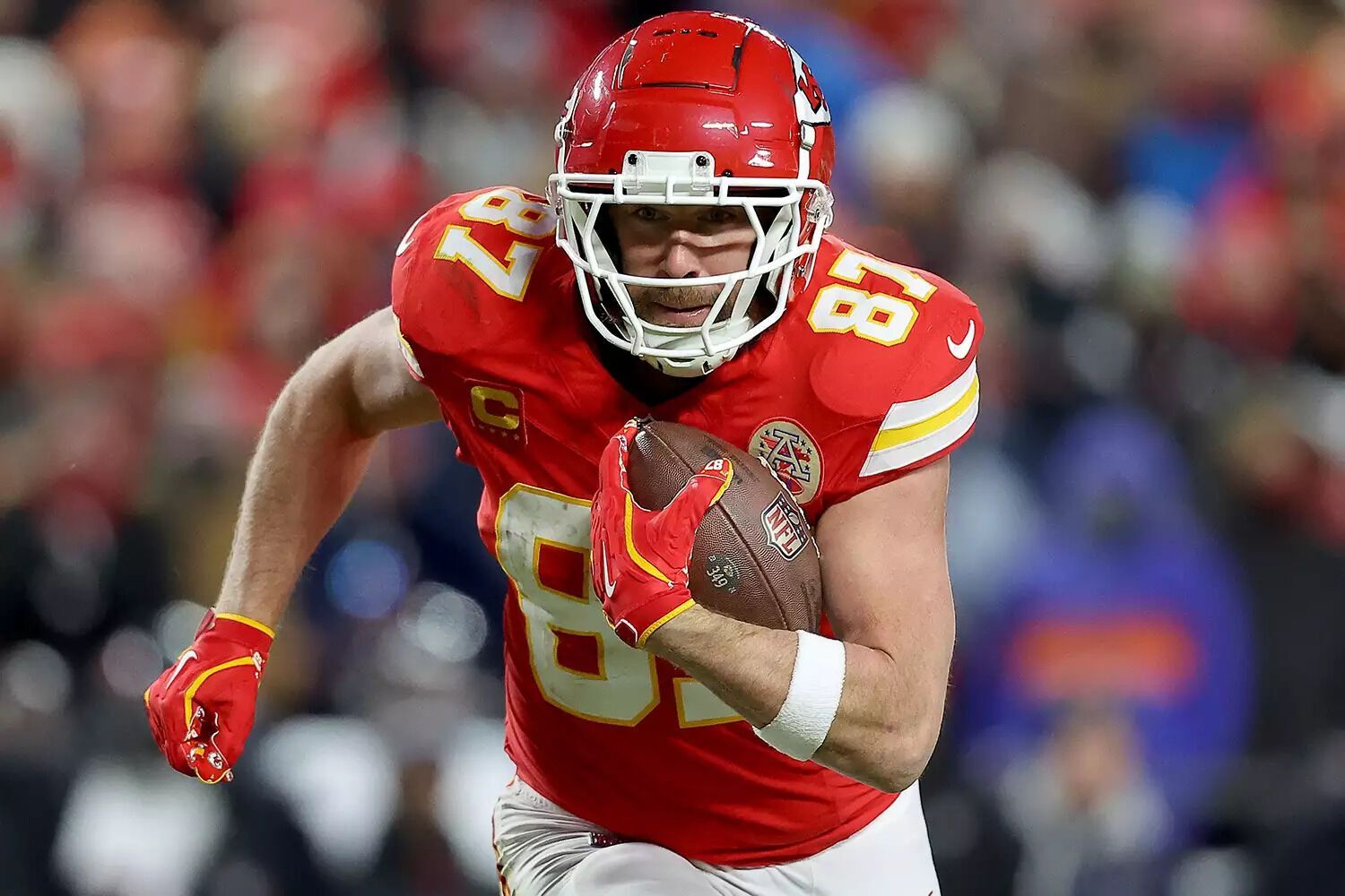 Travis Kelce #87 of the Kansas City Chiefs carries the ball against the Houston Texans