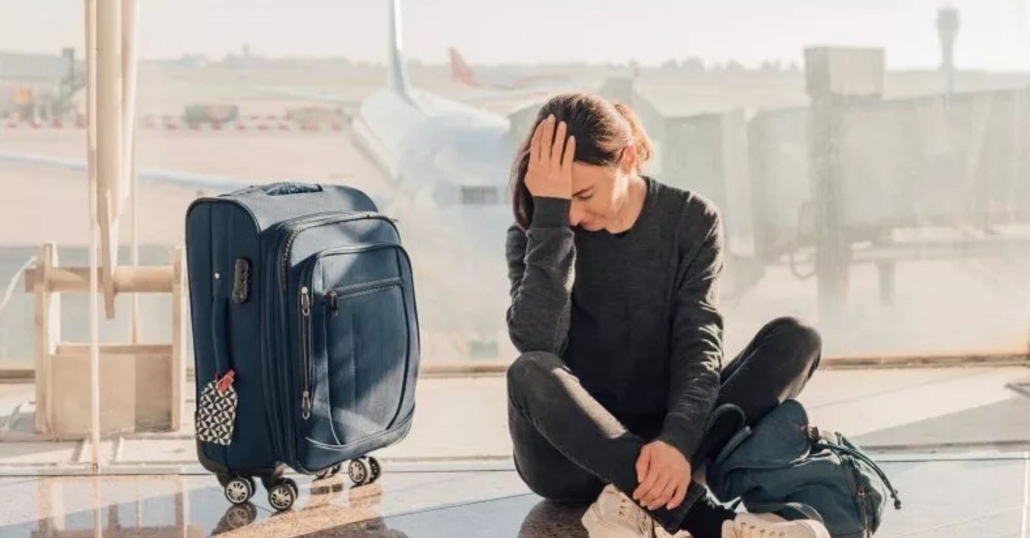 Embarassed woman with a luggage