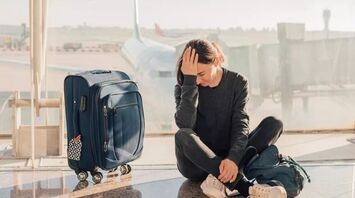 Embarassed woman with a luggage
