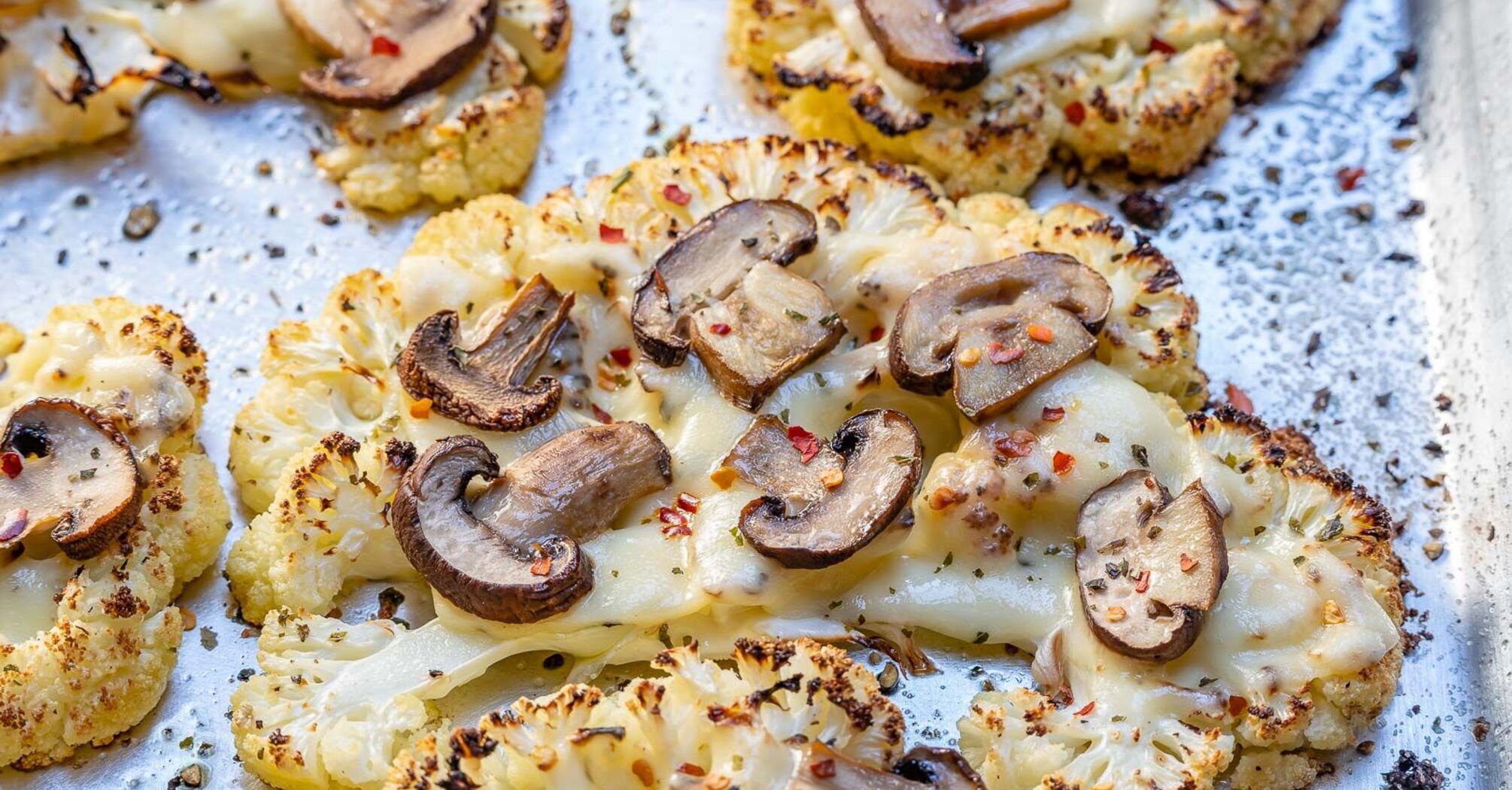Cauliflower steaks with mushrooms and cheese in the oven