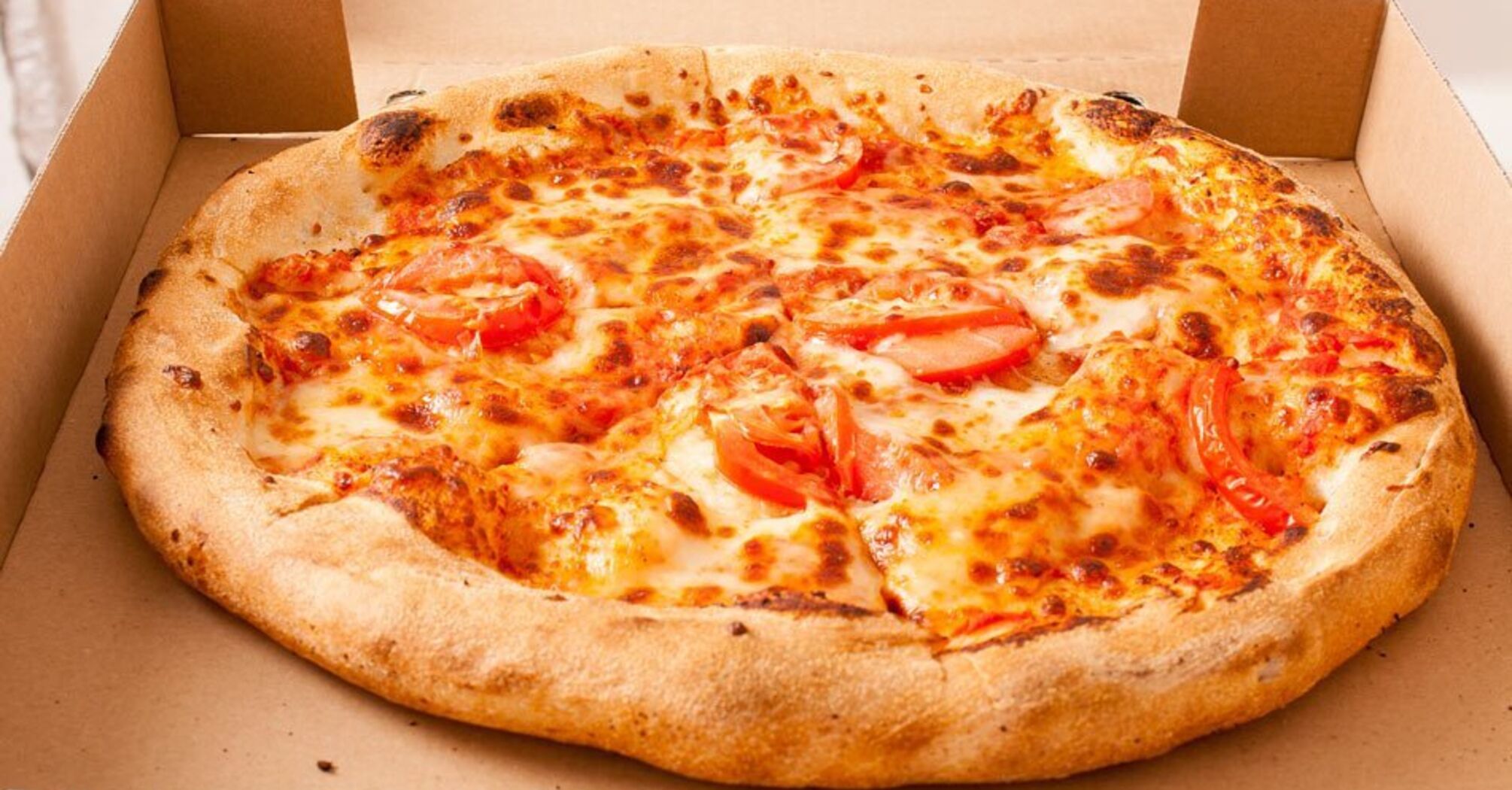 Why a round pizza is put in a square box and cut into eight triangles