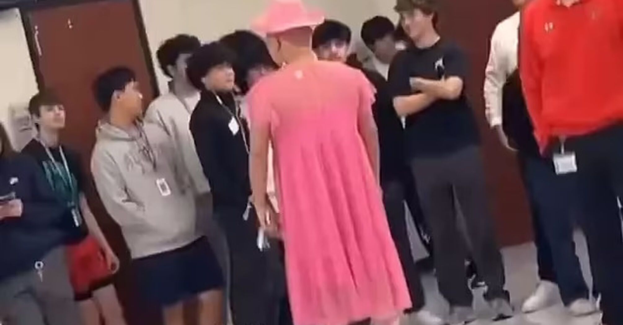 Teacher suspended after video shows him walking around school in a dress