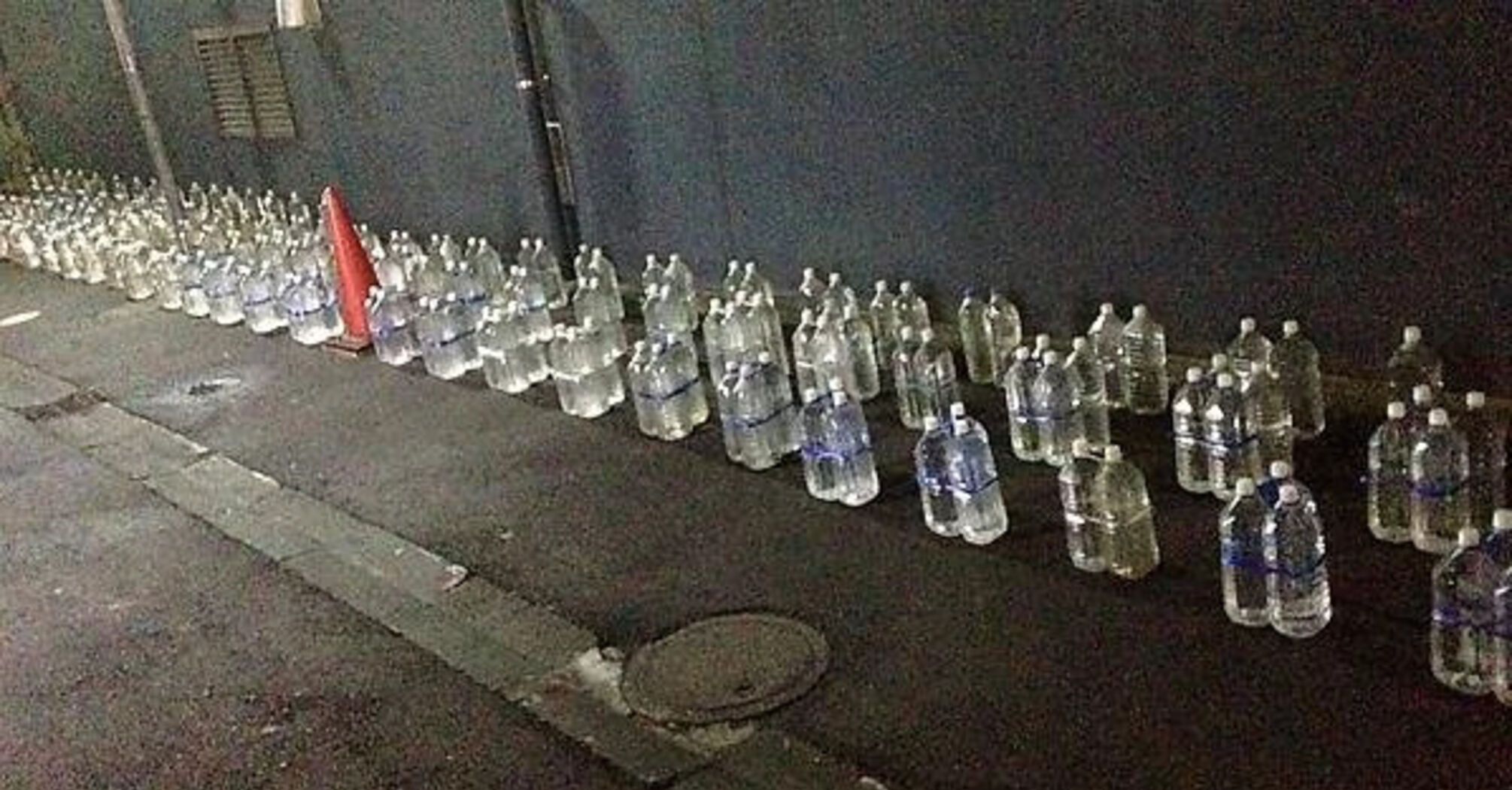 Why do the Japanese place bottles of water near their houses