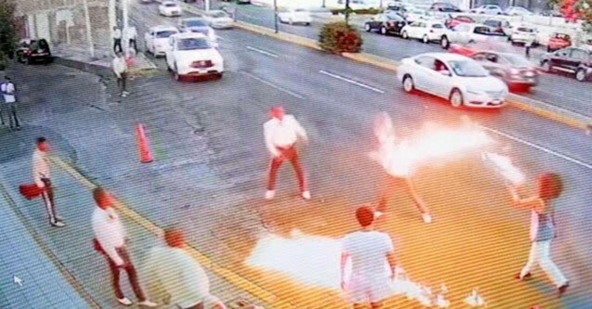  A fire-breather defends street corner against mariachi band