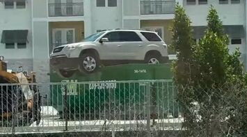 Mysterious SUV Perched on Dumpster in Florida
