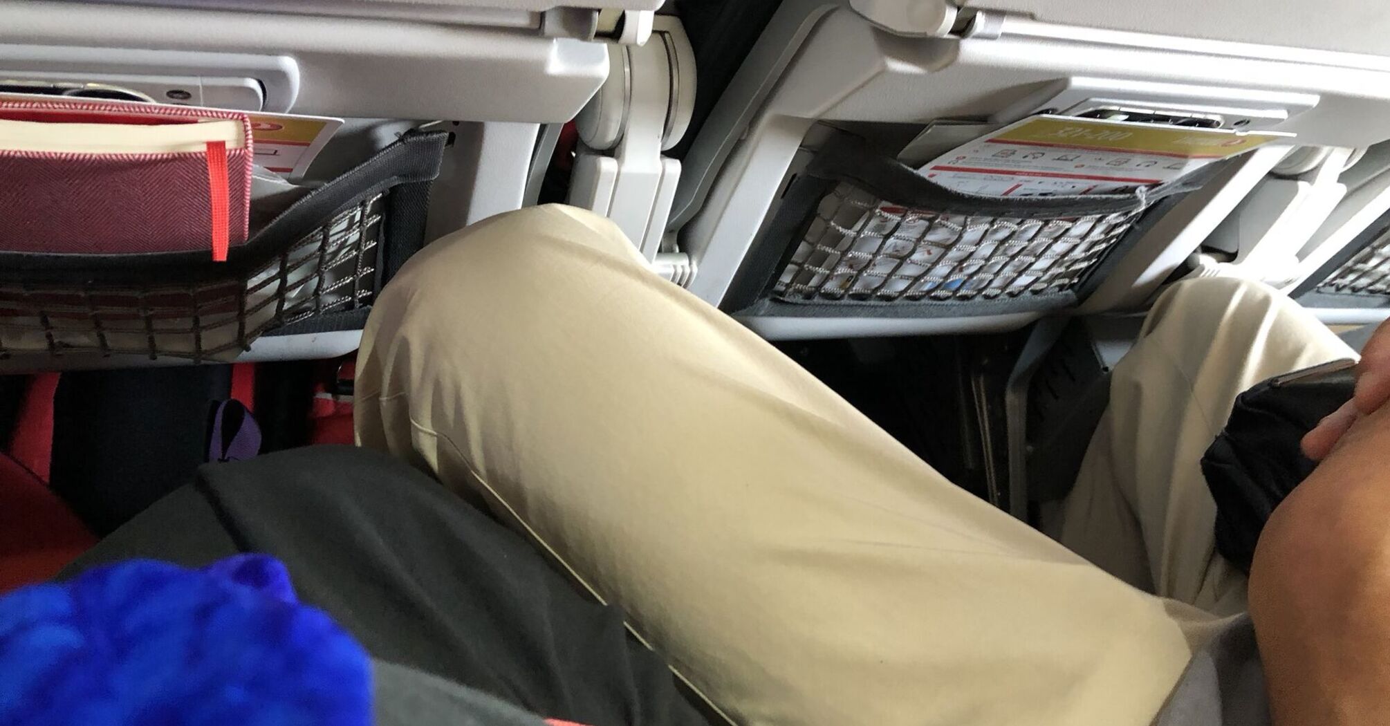 Woman Frustrated After Manspreading on Airplane